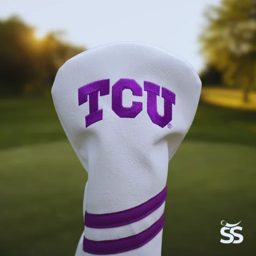 A white driver headcover with TCU in purple