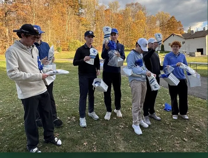 A high school golf team on the course opening their custom Swing Supplies headcovers